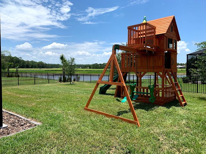 Outdoor swing and playset installation securely assembled in backyard